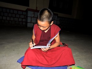 A young Monk studying and preparing for Exam